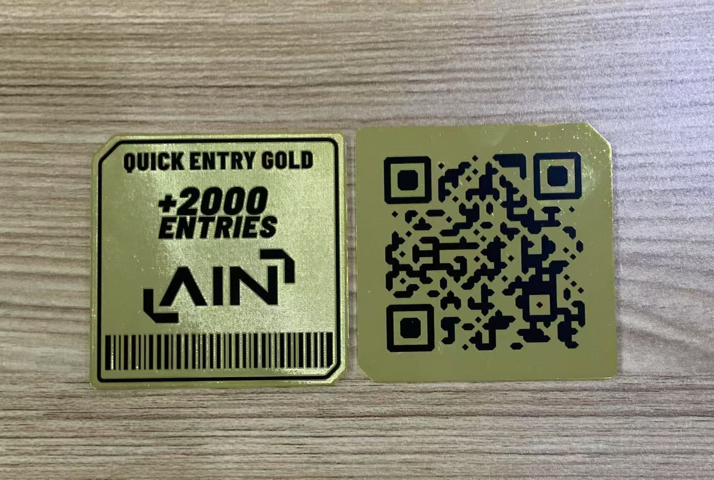 Gold card with QR code and text on a wooden surface. custom gold business card in metal