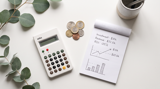 ROI calculation concept with calculator and notepad on a clean desk