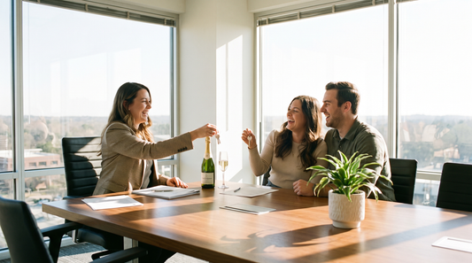 Real estate agent closing a deal with clients at a signing table