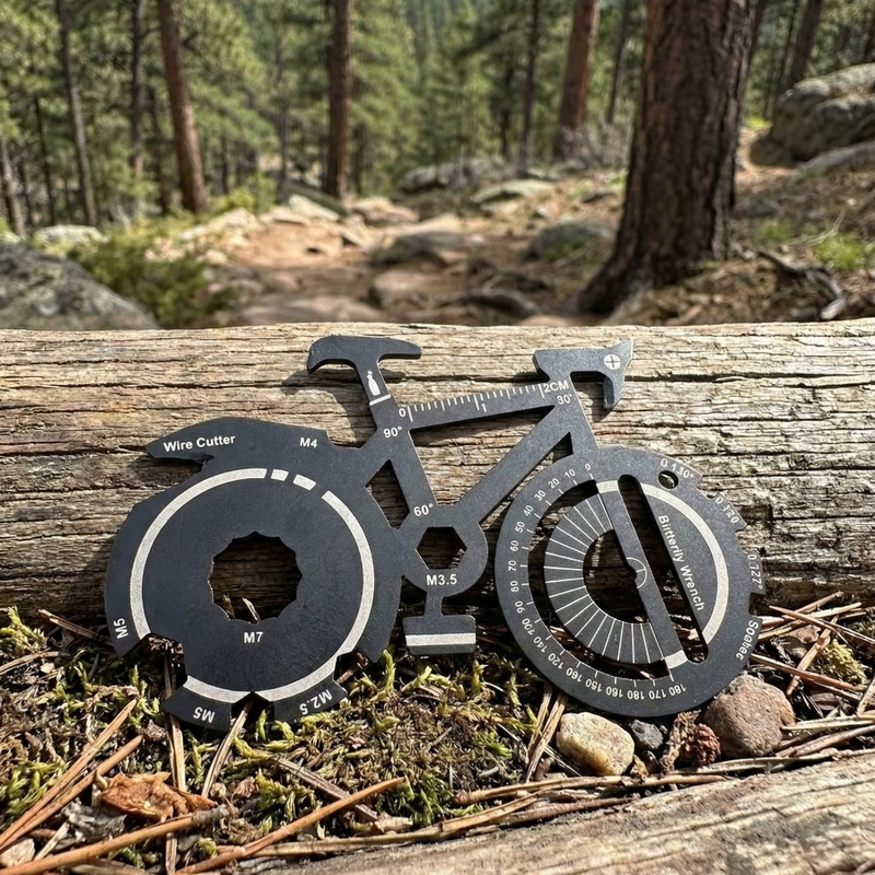 Multitool shaped like a bicycle for promotional events on a log with a forest background