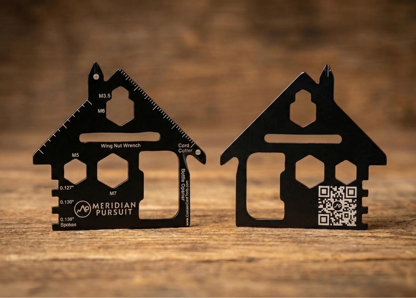 Two black house-shaped tools on a wooden surface with 'Meridian Pursuit' branding.