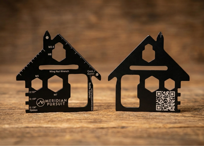 Two black house-shaped tools on a wooden surface with 'Meridian Pursuit' branding.