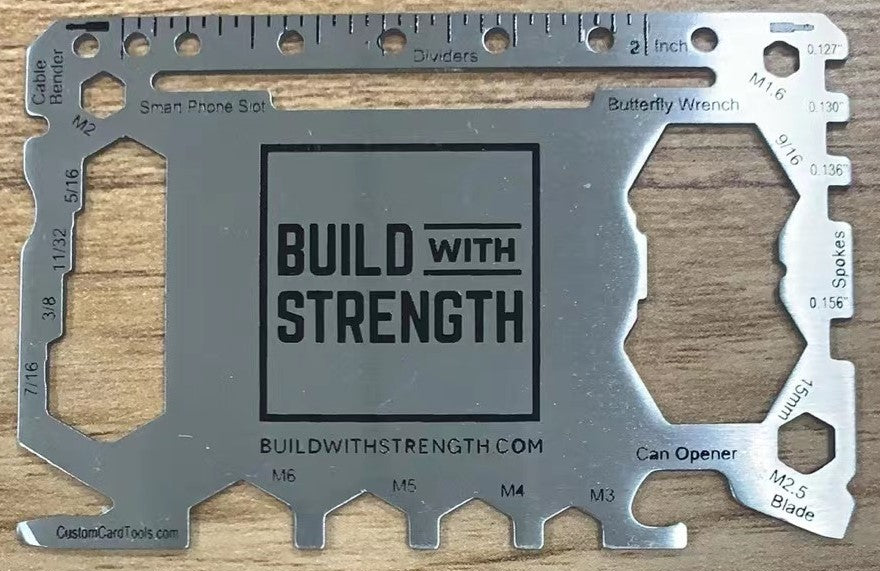 Multitool card with 'Build with Strength' branding on a wooden background