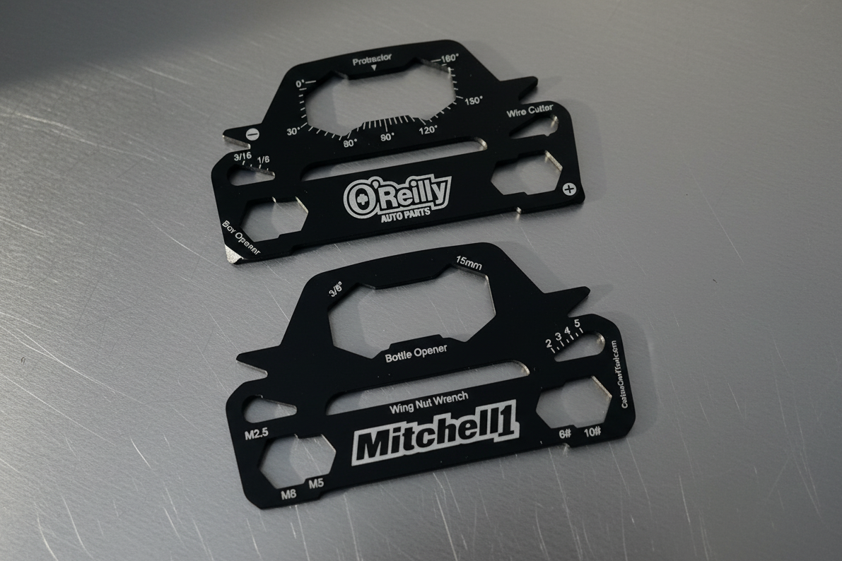 Two black car shaped multi-tool cards with O'Reilly and Mitchell branding on a light background. for automotive promotion